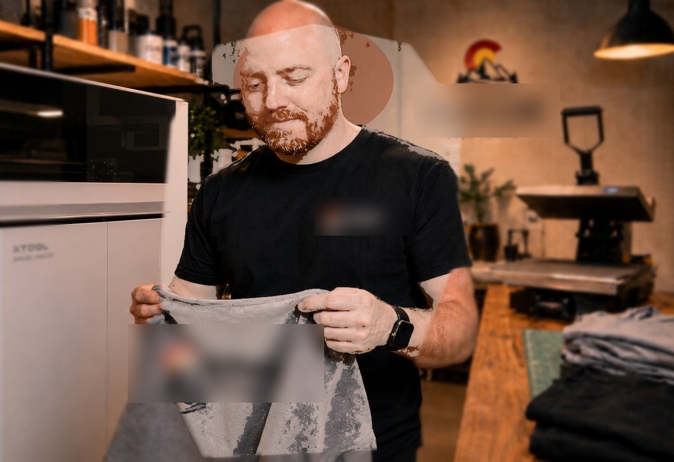 Johnny, owner of Mile High Custom Prints, checking a shirt fresh off the press